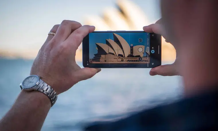 Capturing the iconic Sydney Opera House using a smartphone with a scenic background, adwords sydney